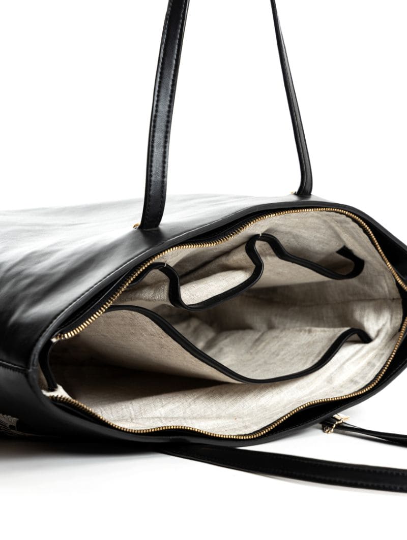 Interior view of Antheia plant-based leather tote bag showing spacious compartments, inner pockets, and organized storage for daily essentials