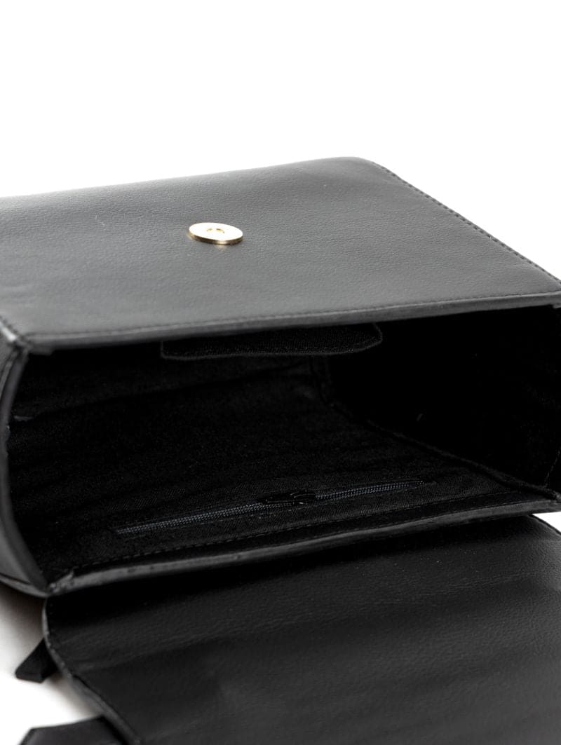 Interior view of Asteria black plant-based leather crossbody bag showing main compartment, inner zip pocket, and structured flap closure