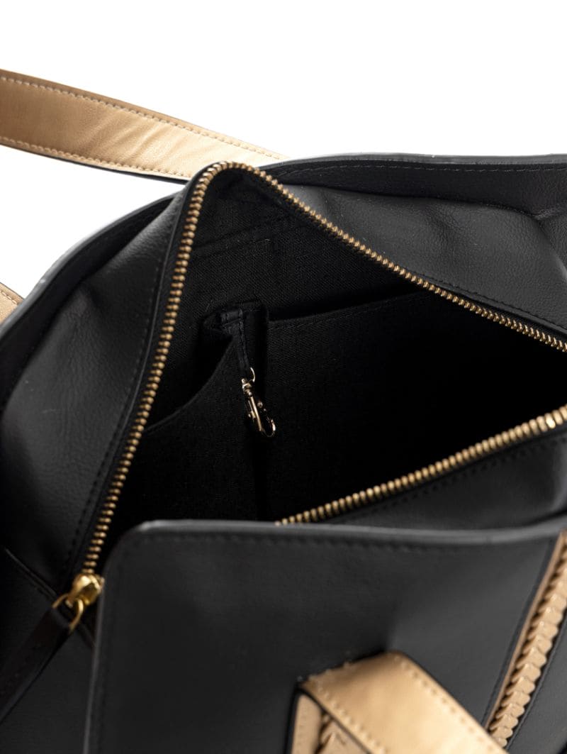 Gaia black and gold plant leather shoulder bag interior view showing zip closure and organized compartments for everyday essentials