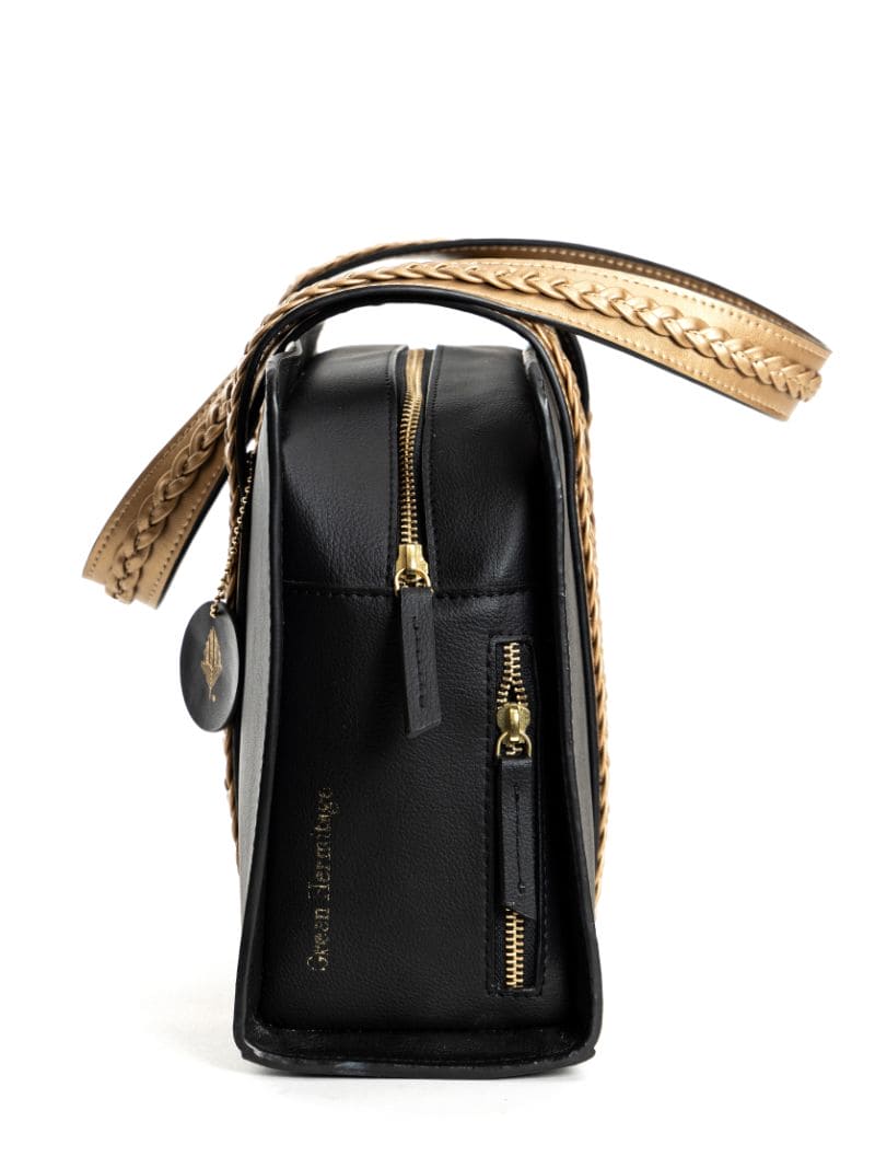 Gaia black and gold plant leather shoulder bag side view showing structured shape zipper closure and compact profile
