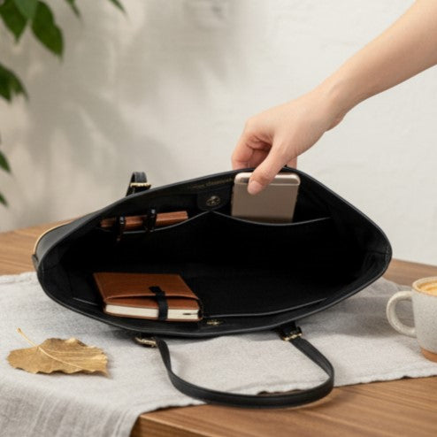 Minerva black plant leather tote bag showing spacious interior compartments with phone and essentials