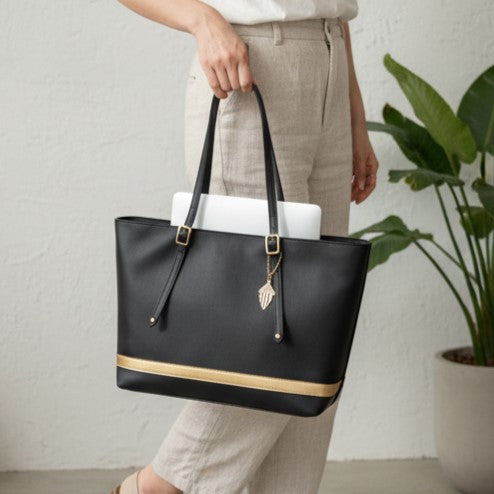 Minerva black plant leather tote bag carried by person showing work and everyday use