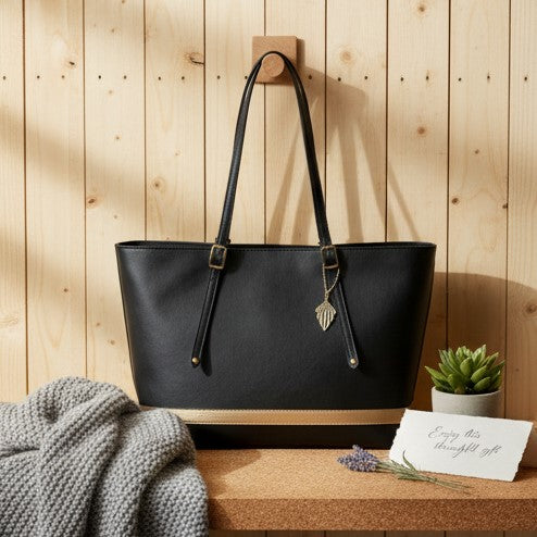 Minerva plant leather tote bag in black with structured design placed on wooden background