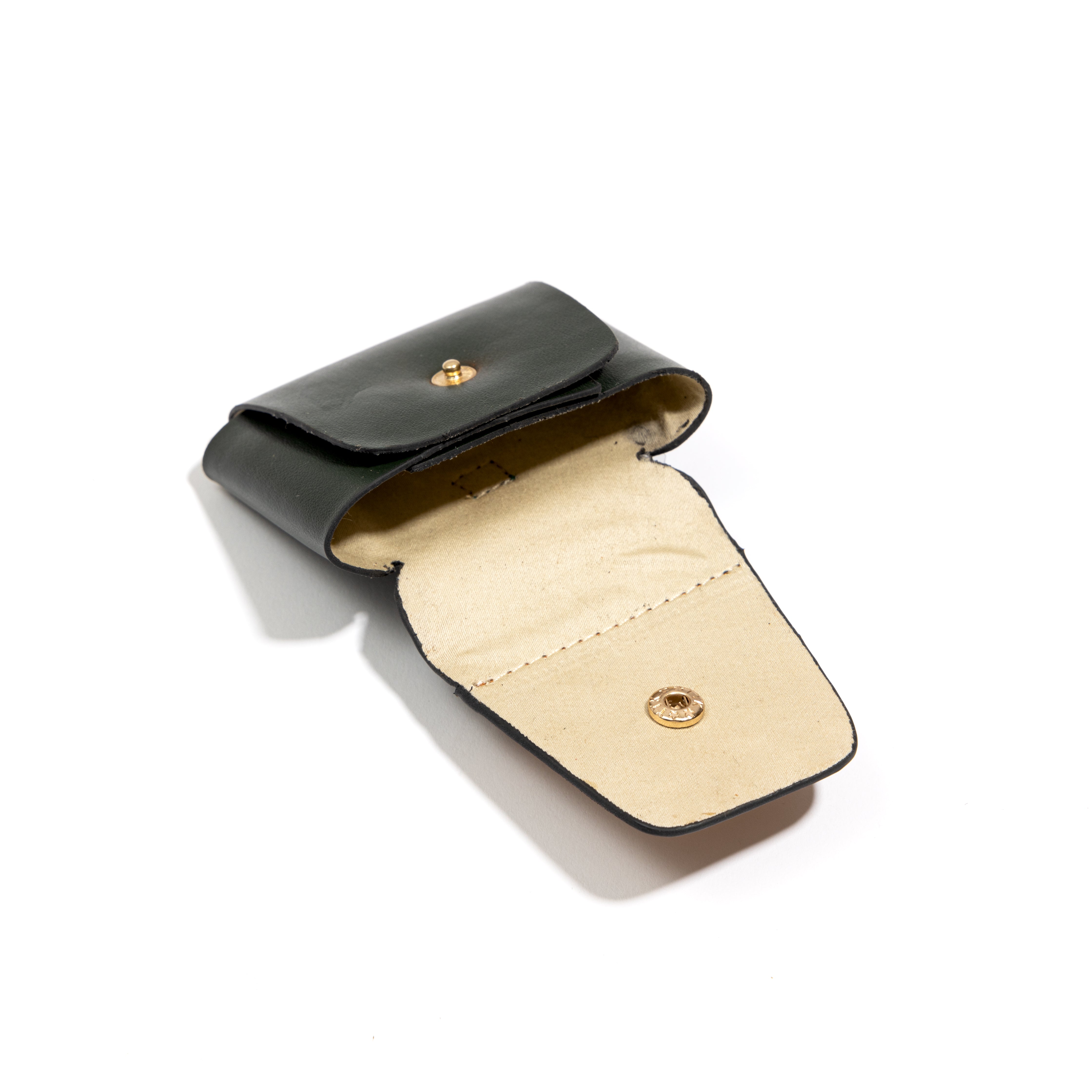 Plant leather AirPods cover open showing interior from the Basil Holiday Travel Set by Green Hermitage