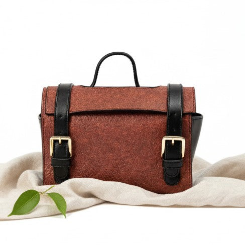 Plant leather travel utility kit in madder red and black with buckle straps and handle by Green Hermitage.