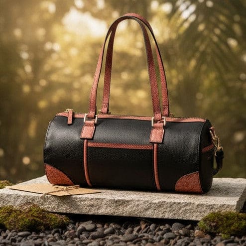 Salacia plant leather bowler bag in black and madder red displayed outdoors, handcrafted with fairtrade canvas, cactus leather and malai leather for everyday use.