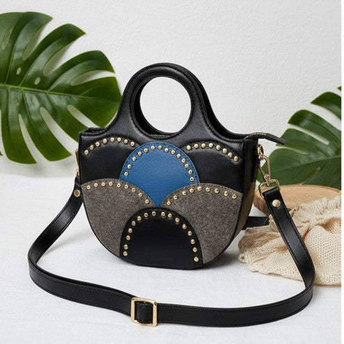 Savannah Black plant leather sling bag front view featuring sculpted cutout handle and adjustable strap by Green Hermitage