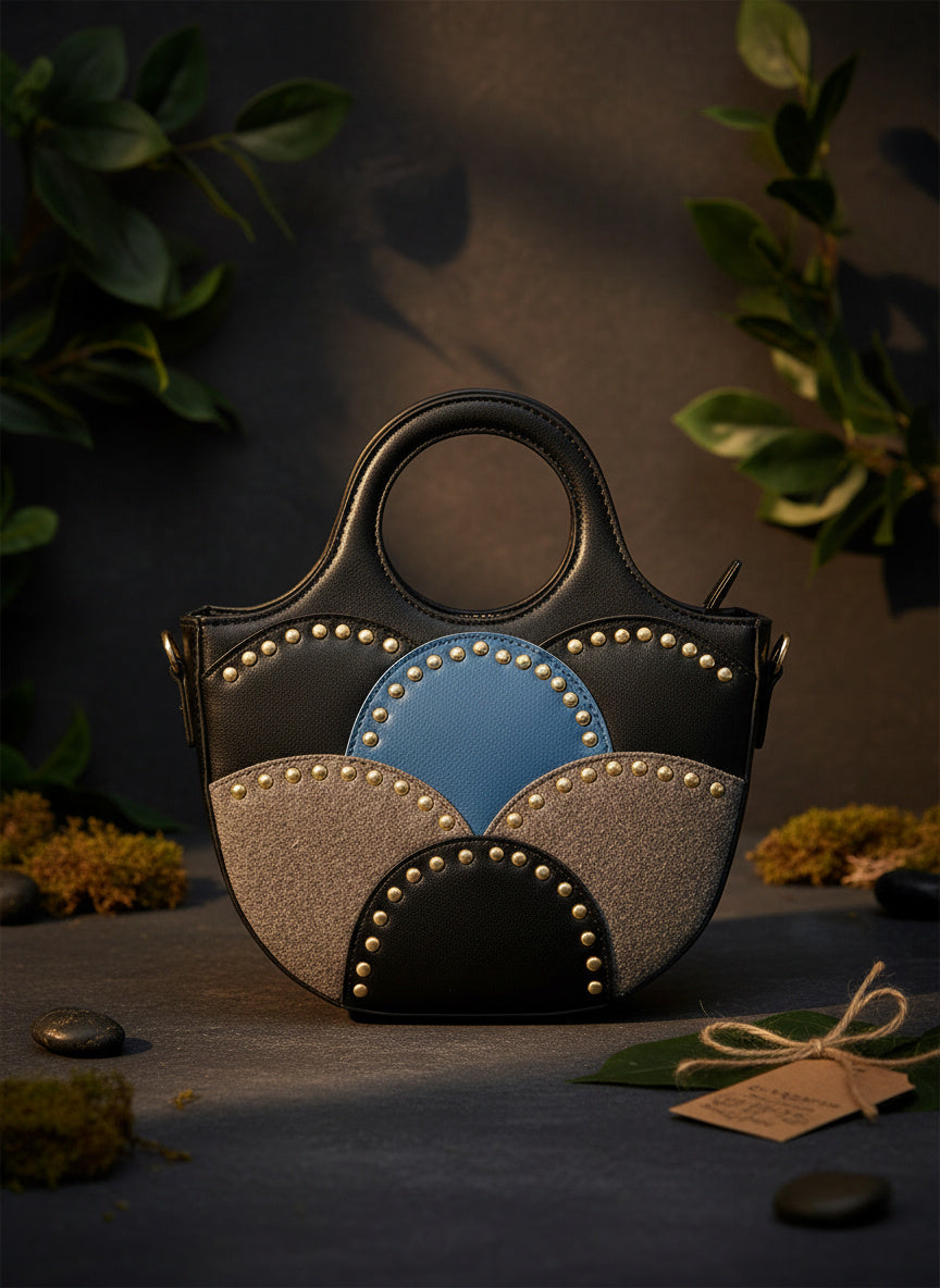 Savannah Black plant leather sling bag studio shot with sculpted handle and geometric panel detailing by Green Hermitage