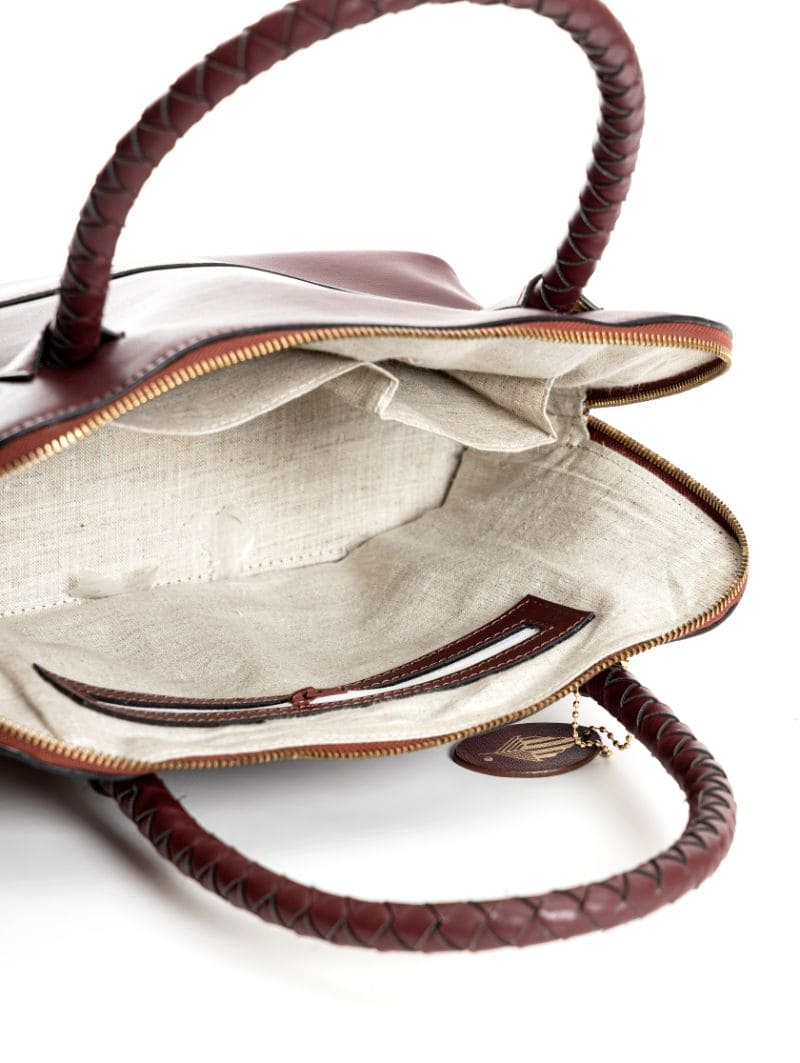 Theia red plant-based leather shoulder bag interior view showing hemp lining and organized compartments