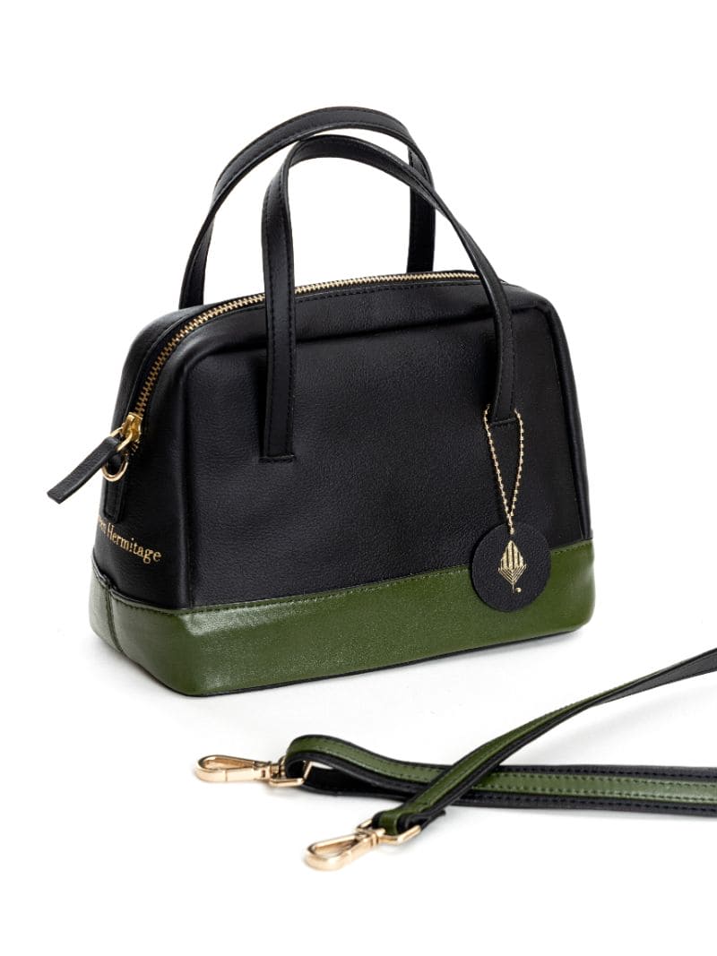 Vanadey plant leather satchel crossbody bag in black and green with detachable strap displayed on white background
