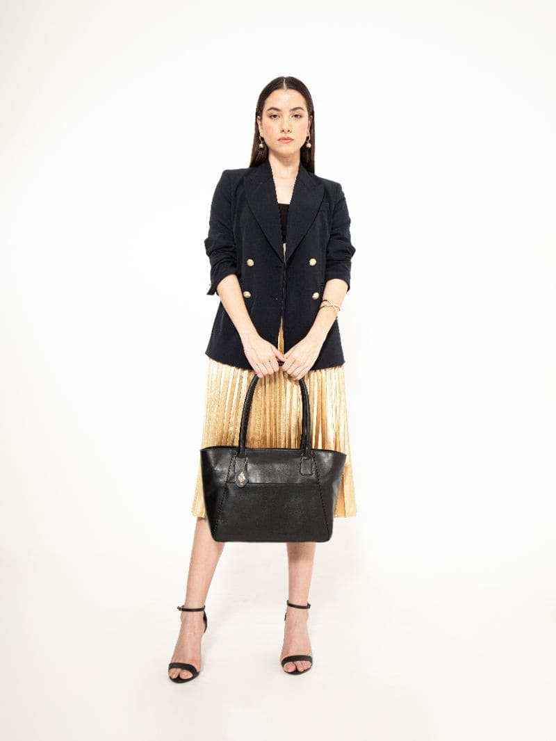 Model carrying Athena black plant-based leather tote bag showcasing size, structure, and everyday styling