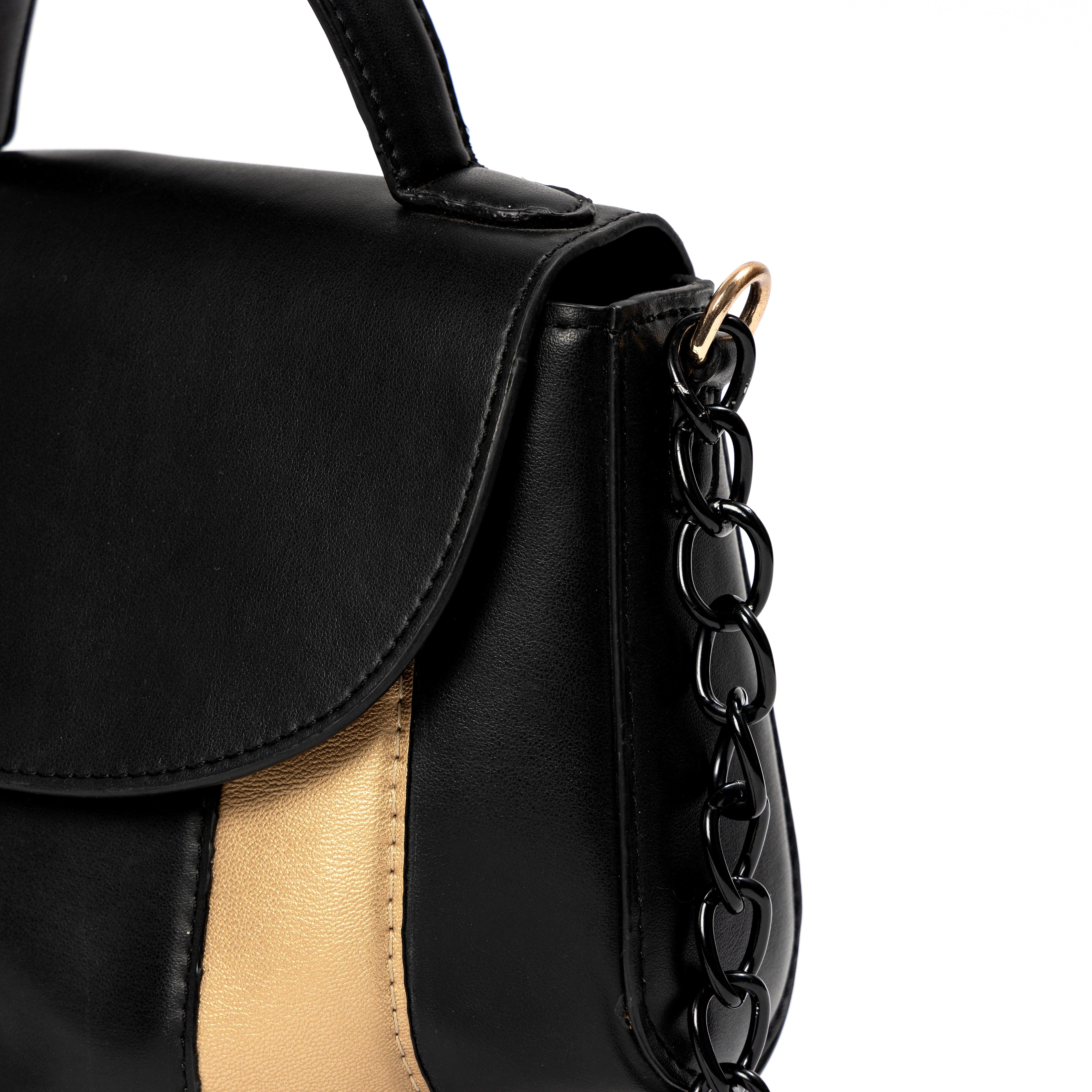 Close-up of Aurora black and gold plant-based leather sling bag showing chain strap and side detail