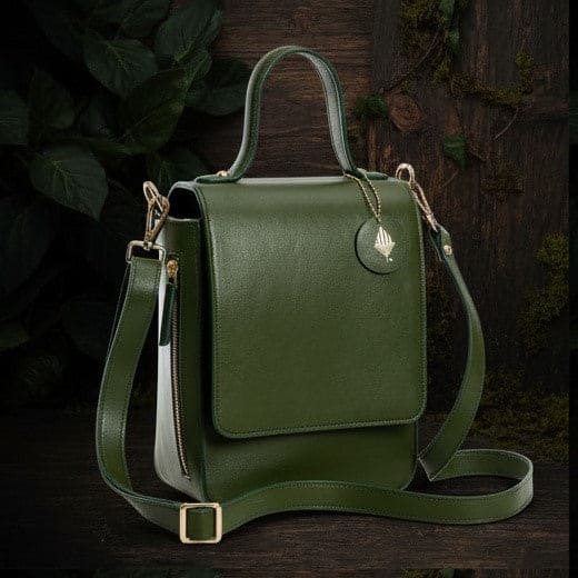 Ceres green plant leather crossbody bag with structured silhouette and adjustable strap on a dark natural background