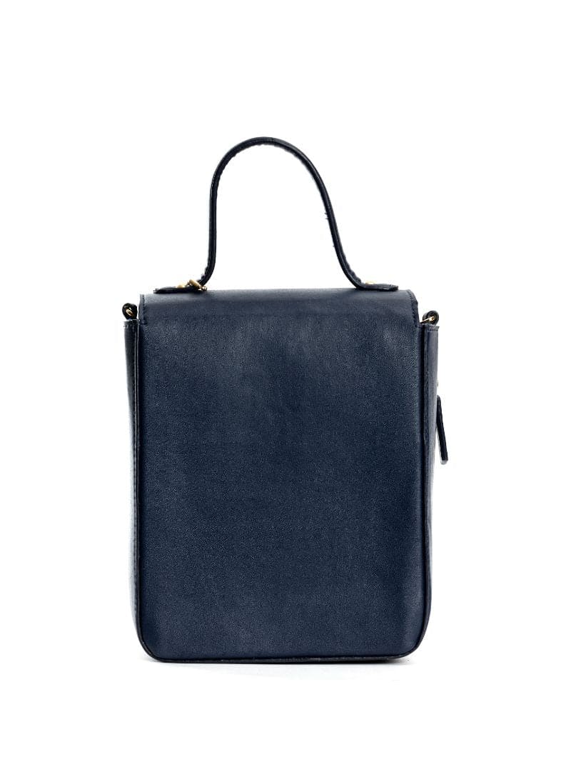 Back view of Ceres navy blue plant-based leather crossbody bag with structured silhouette on a clean white background