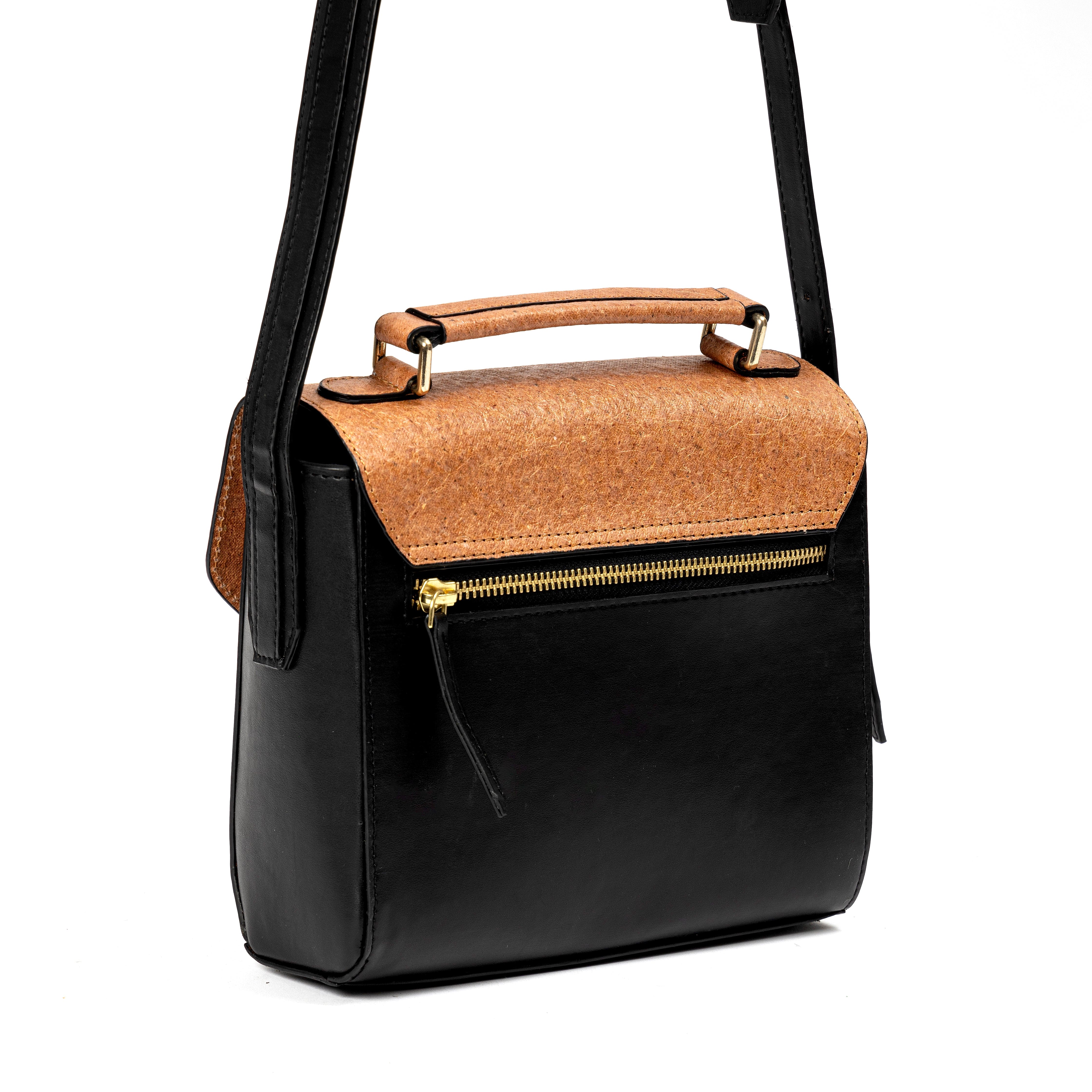 Back view of black and coconut orange plant leather sling bag with gold zipper pocket and top handle on a white background