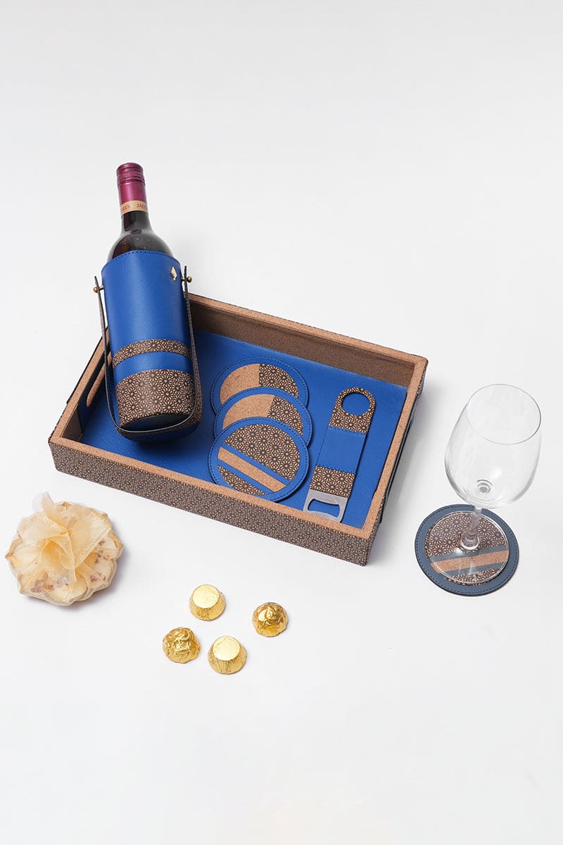 Luxury bar accessories set with bottle holder, coasters and opener arranged on a serving tray by Green Hermitage