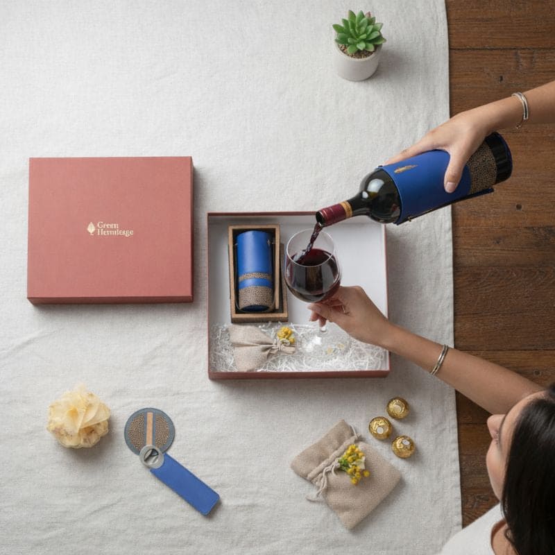 Luxury bar gift set by Green Hermitage with wine bottle holder and accessories being used to pour wine into a glass