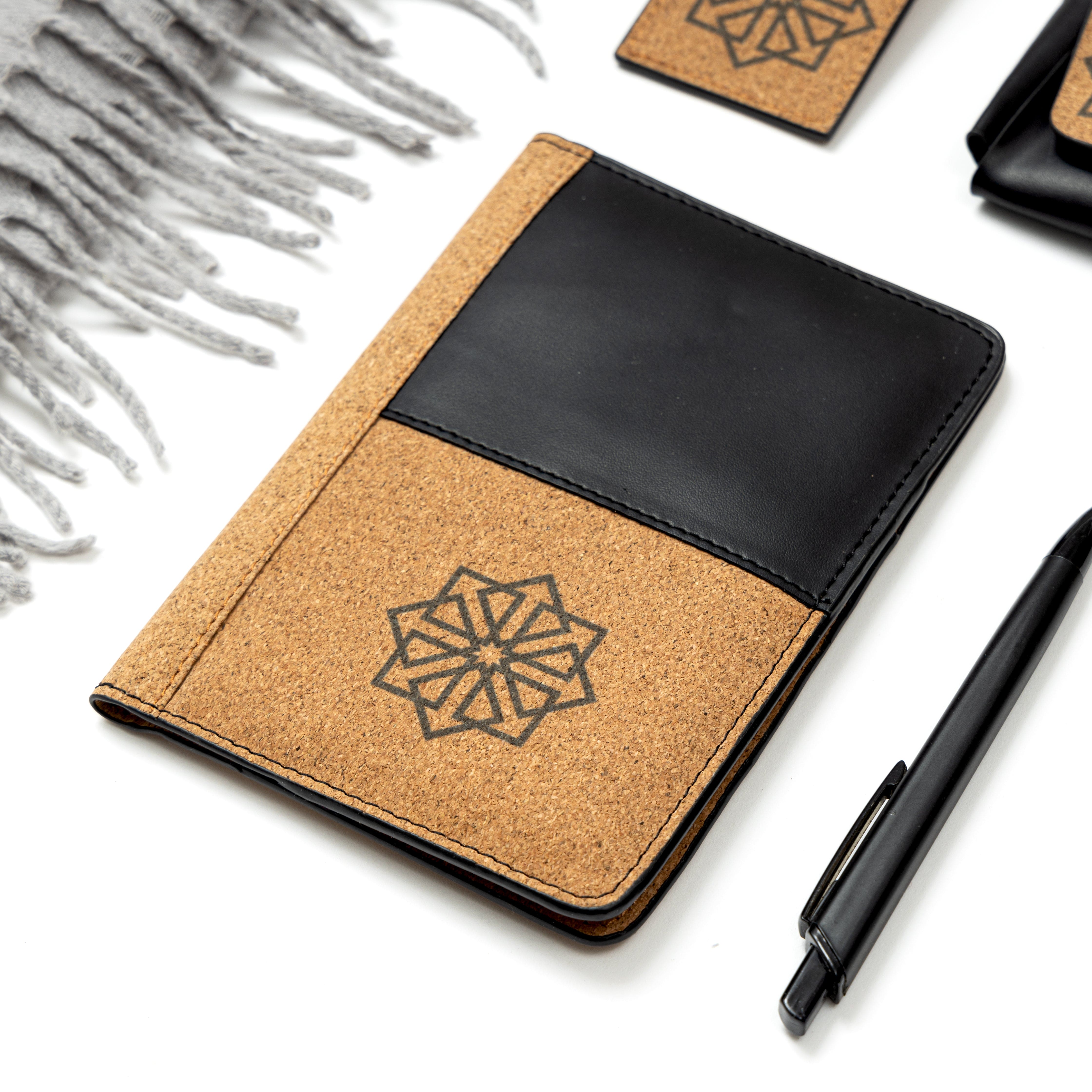 Plant leather passport holder from the Noir Holiday Travel Set by Green Hermitage with cork and black leather design