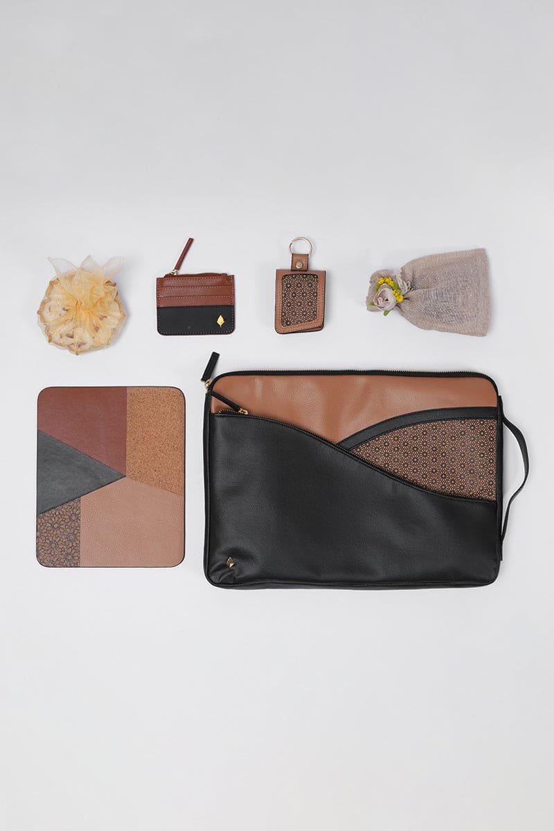Workday Wonders office gift set by Green Hermitage showing plant leather laptop sleeve, mouse pad, card wallet and keychain arranged as sustainable office accessories